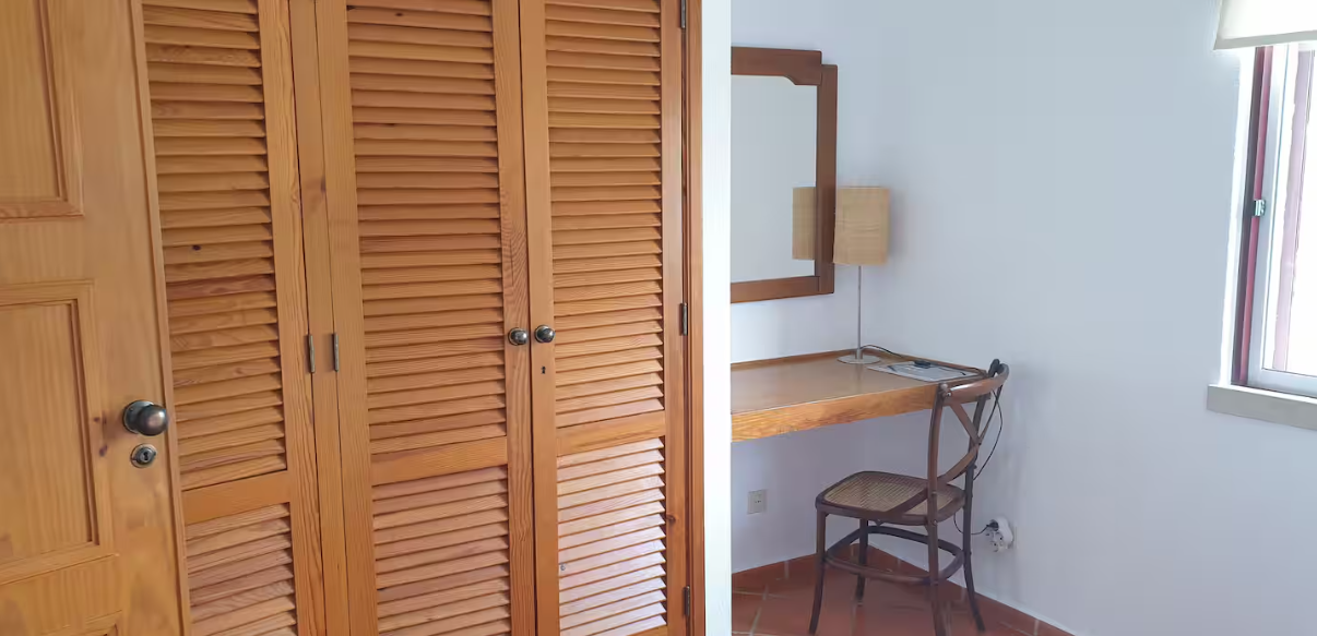 Bedroom with two single beds, wardrobe and dressing table.